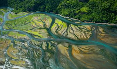 A glacial river branches out in a broad coastal delta and meets the North Pacific Ocean. Credit: Steve Hillebrand/USFWS