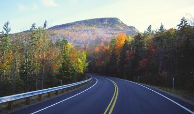 Autumn road to mountains by UNH