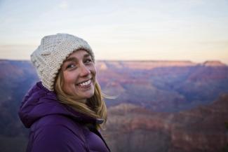 Morgan Lawrence smiling above the Grand Canyon.