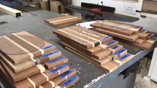 3 piles of wood blocks stacked on a work bench ready for use in the workshop