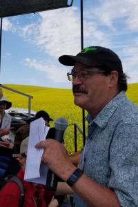 Dave Huggins guides listeners through a field of crops.