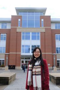 Photo of Ning Zhang in front of a building