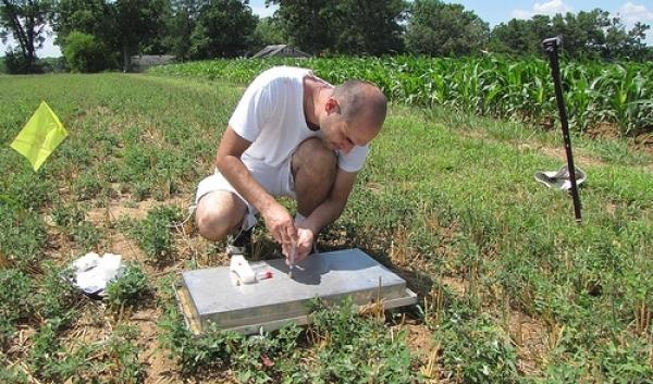 SASL team member graduate student Milutin Djurickovic samples greenhouse gases in the long-term Farming Systems Project. (Photo credit Michel Cavigelli) USDA-ARS