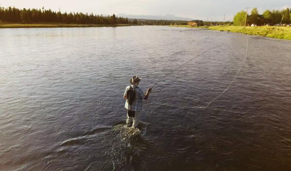A fly fisherman casts a line on the Henry's Fork of the Snake River
